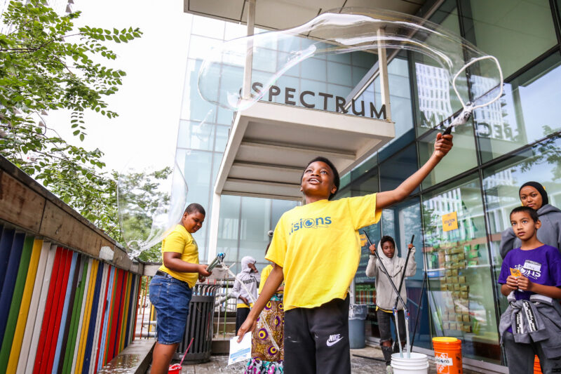 Youth creating large bubbles at 2025 STEM Futures Expo
